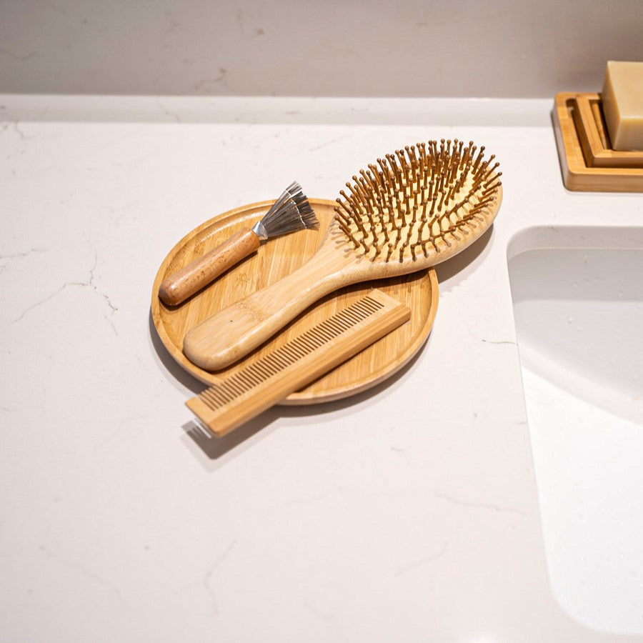 A narrow bamboo comb with precision-spaced teeth.