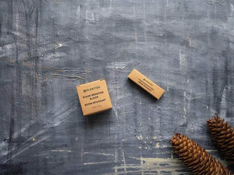 Top View: Plantish Future Home & Kitchen White Stain Remover block (3.5oz) and Stick (0.5oz) in its brown cardboard box with the words "Plantish Stain Remover Block Baton Detachant"